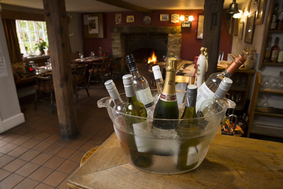 Bottles chilling on ice beside the fireplace
