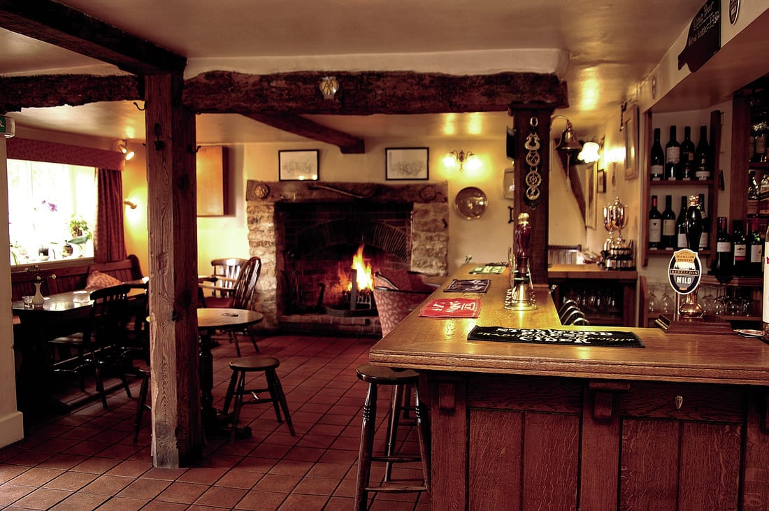 The bar and the inglenook fire, lit for the evening