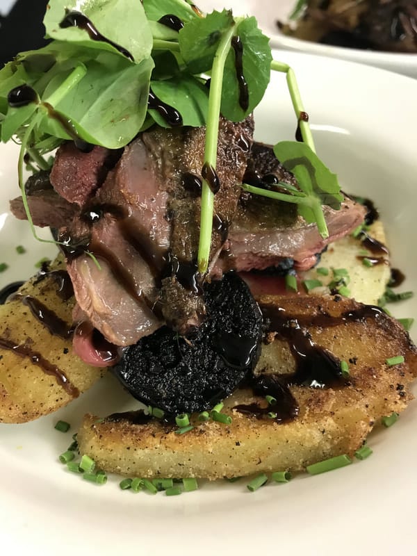 A seasonal main course, plated in the kitchen
