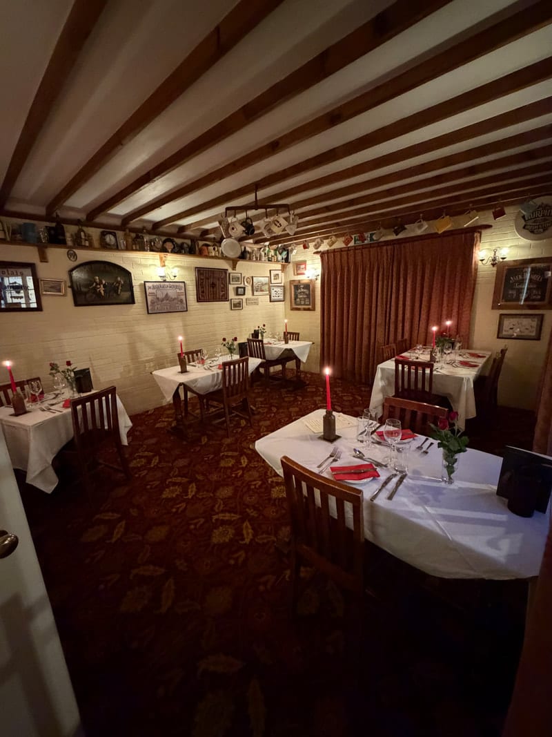 Candlelit tables set in the dining room